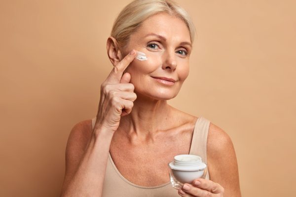 middle-aged-beautiful-woman-applies-anti-aging-cream-face-undergoes-beauty-treatments-cares-about-skin